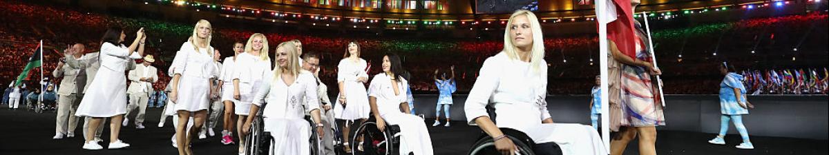 a group of Para athletes walking at an opening ceremony