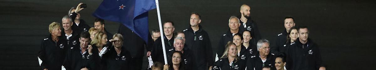 a group of Para athletes walking at an opening ceremony