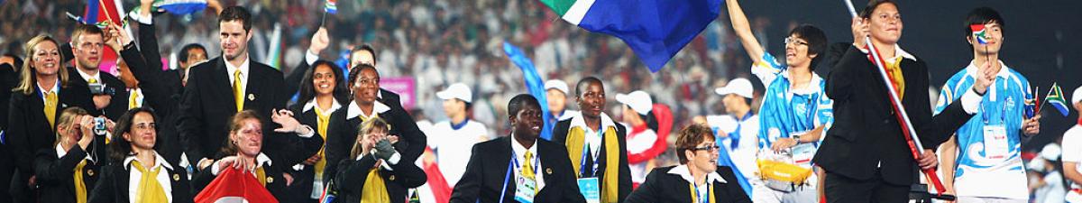 a group of Para athletes walking at an opening ceremony