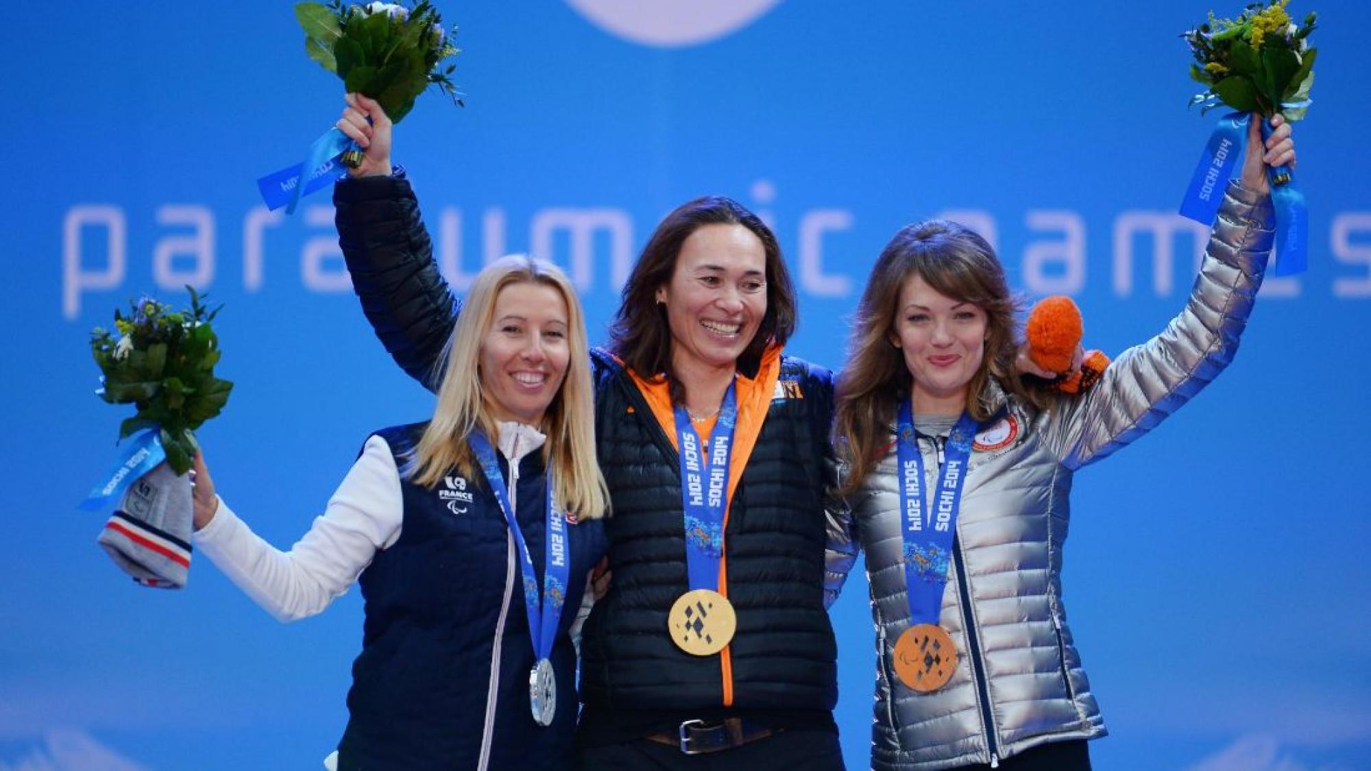 three female Para snowboarders on the podium