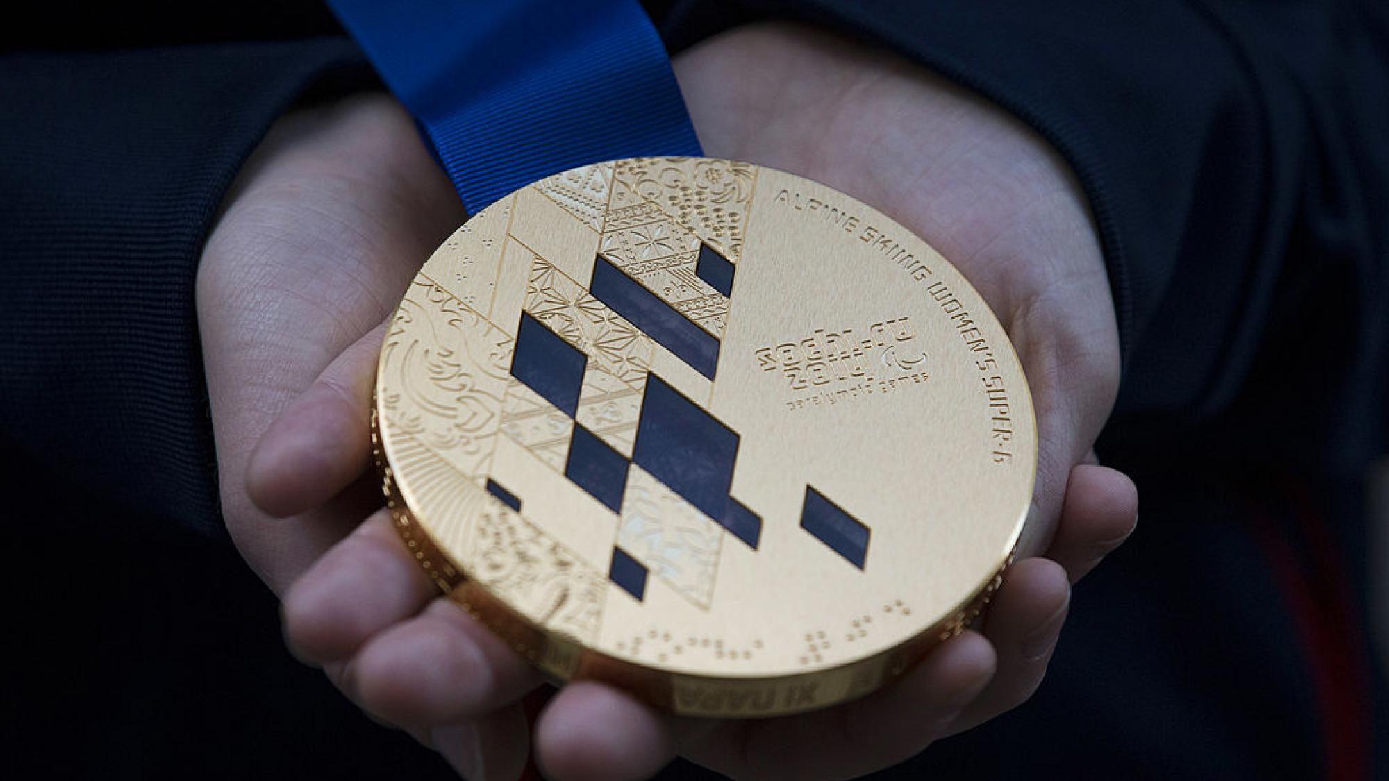 The photo shows a gold medal from Sochi 2014.
