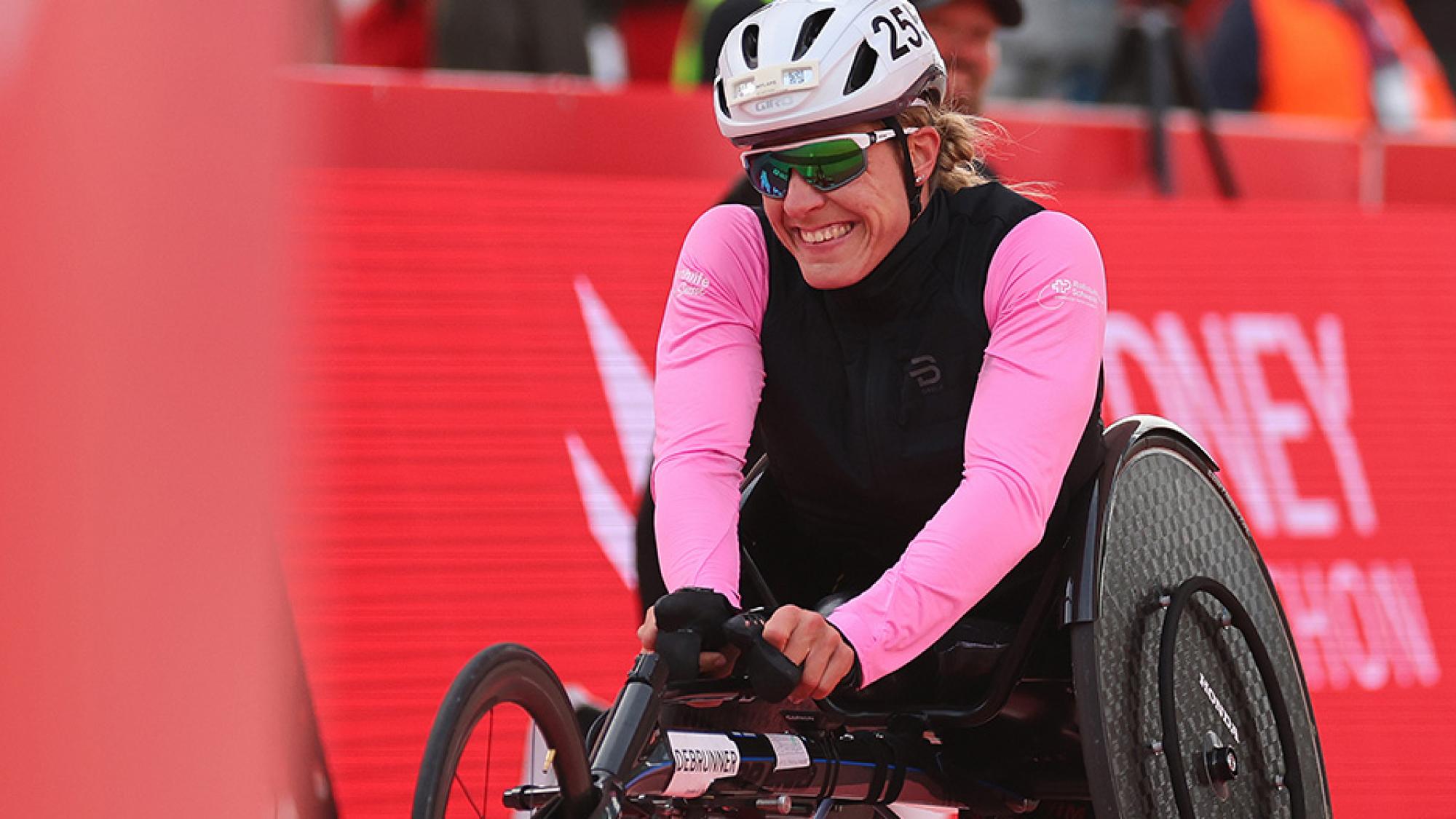 A female wheelchair racer smiling
