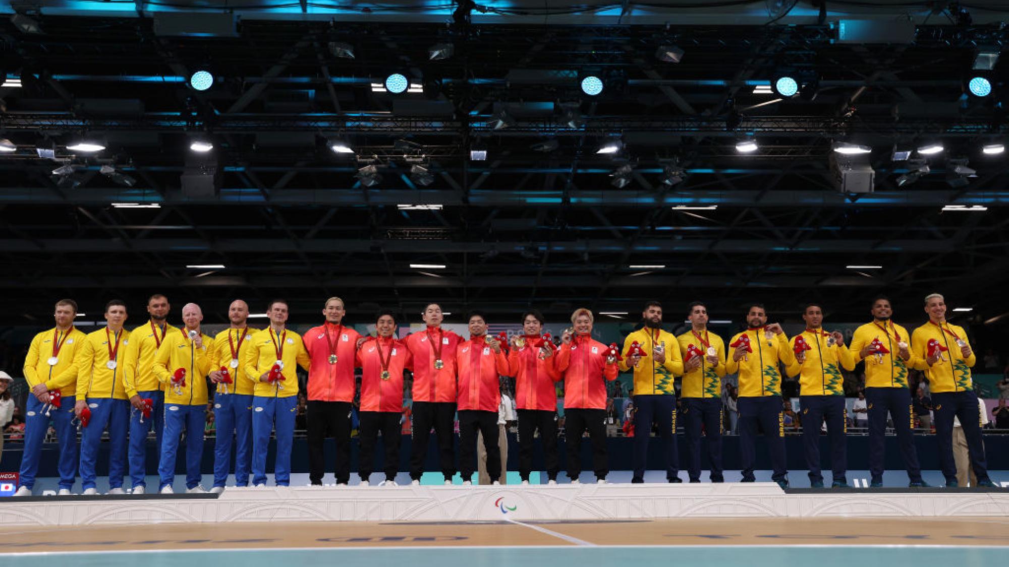 Players from three goalball teams (Ukraine, Japan and Brazil) pose for a photograph on the podium 