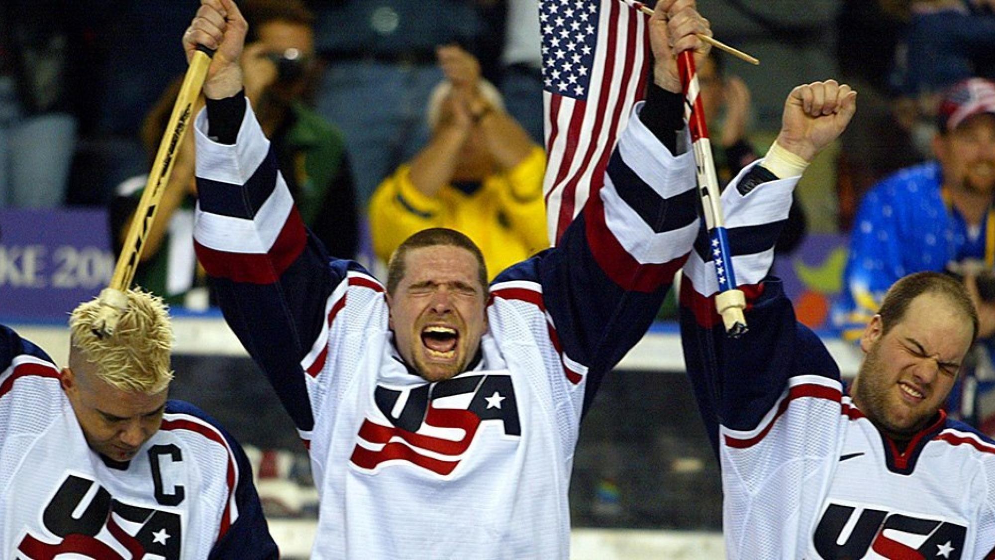 Three USA Para ice hockey players celebrating
