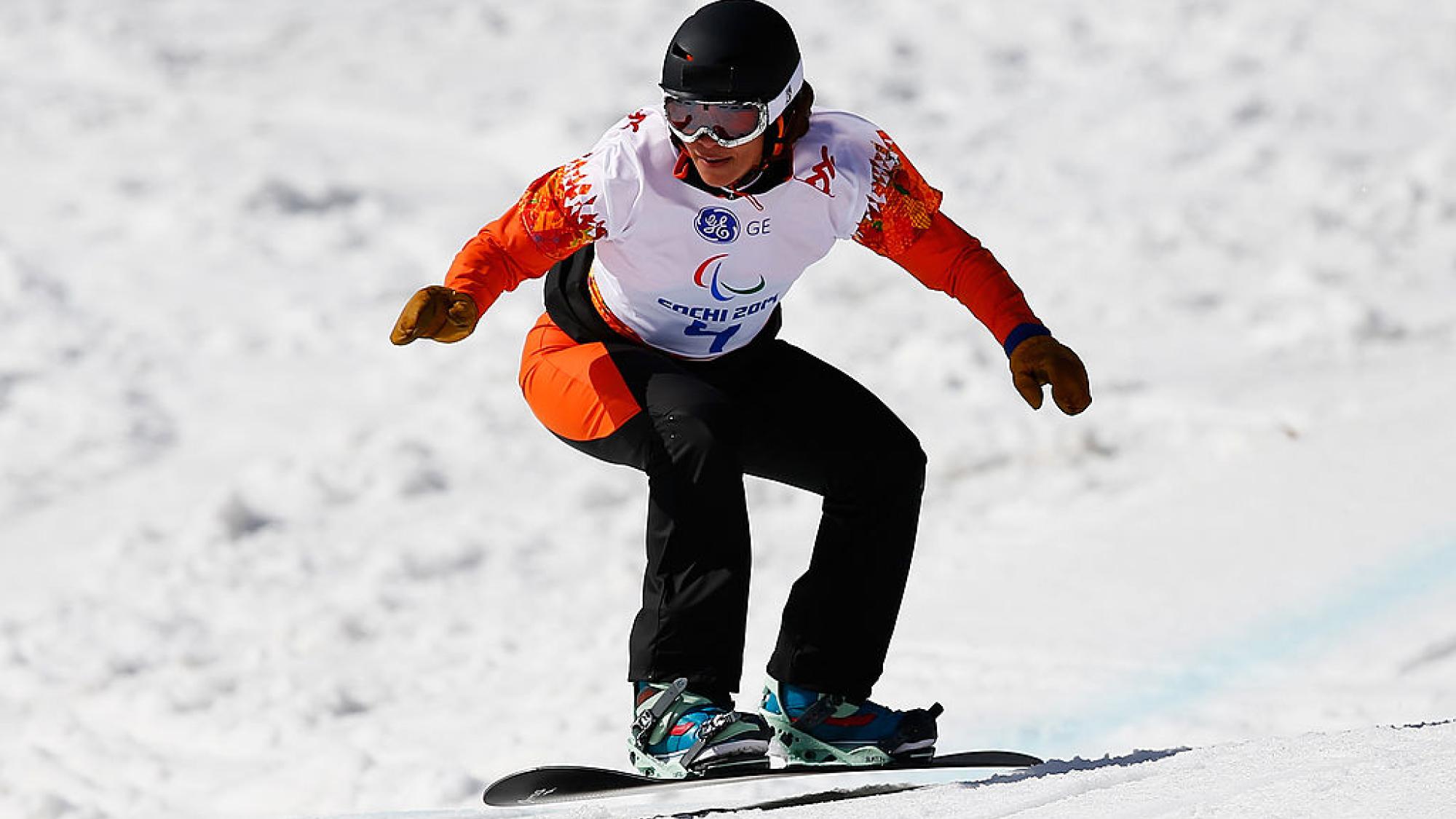A female Para snowboarding athlete in action
