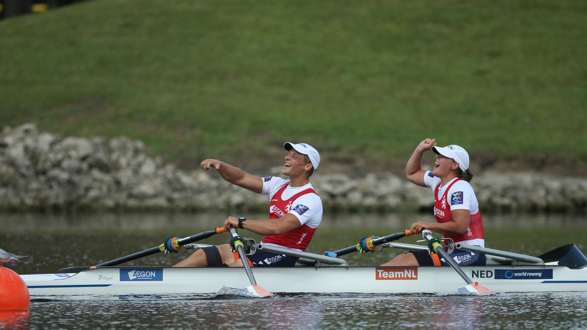 a male Para rower Corne De Koning and female Para rower Annika van der Meer celebrate in their boat