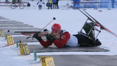 A picture of man shooting with a gun during a Biathlon race