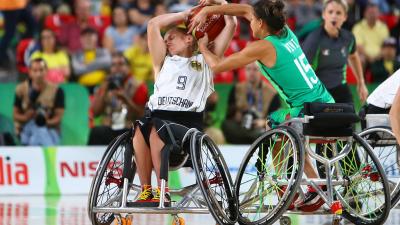 female wheelchair basketball player Laura Fuerst fighting with another player for the ball