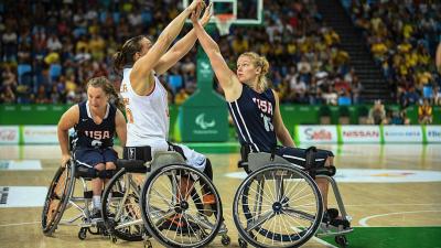 Female wheelchair basketball player Mariska Beijer fighting with another player for the ball 