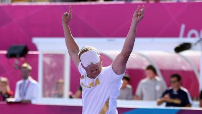 a blind footballer raises his arms in celebration