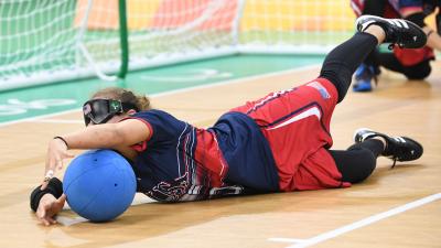 a female goalball player saves a shot