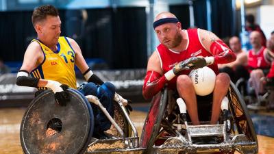 male wheelchair rugby player Stefan Jansson tackles another player