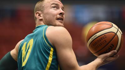 male wheelchair basketball player Jannik Blair holding a ball and looking over his shoulder