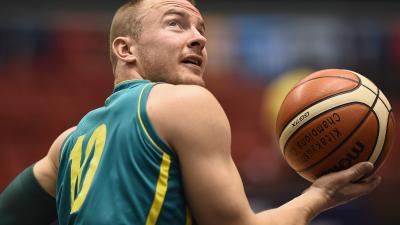 male wheelchair basketball player Jannik Blair holding a ball and looking over his shoulder