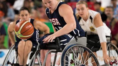 female wheelchair basketball player Rose Hollermann rolls with the ball