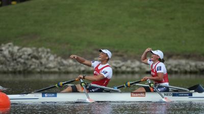 female and male Para rower Annika van der Meer and Corne de Koning celebrate in their boat