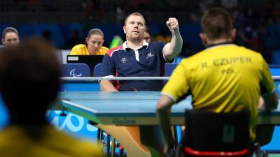 male Para table tennis player Fabien Lamirault punches the air after a shot