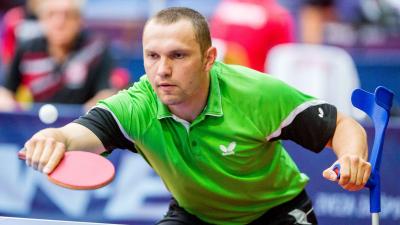 male Para table tennis player Viktor Didukh plays a forehand