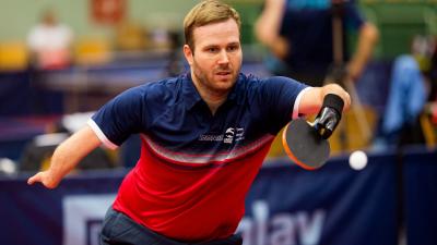 male Para table tennis player Peter Rosenmeier plays a forehand