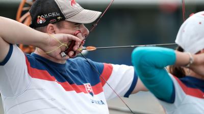 male Para archer Marcel Pavlik pulls back an arrow ready to shoot