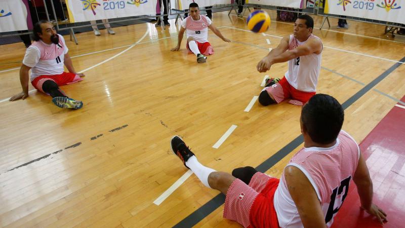 Peruvian sitting volleyball player Bruno Jose Quiros Davalos hits the ball