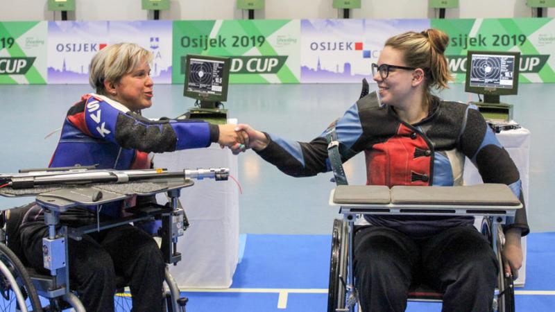 Veronika Vadovicova fist bumps athlete after winning gold.