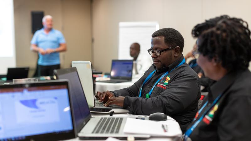 Delegates from NPC Guyana work with their laptops during OCP workshop