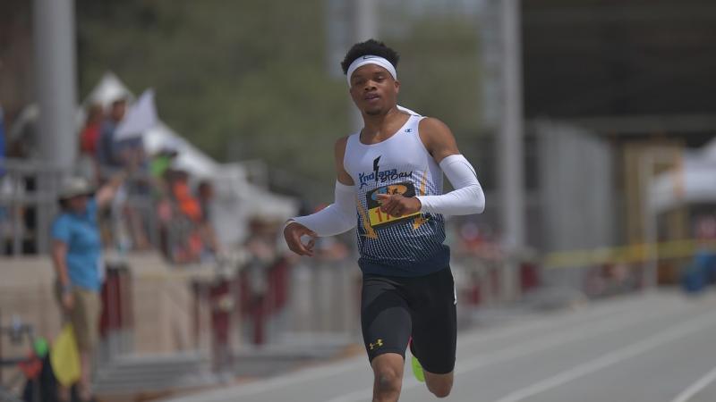 A man running on an athletics track