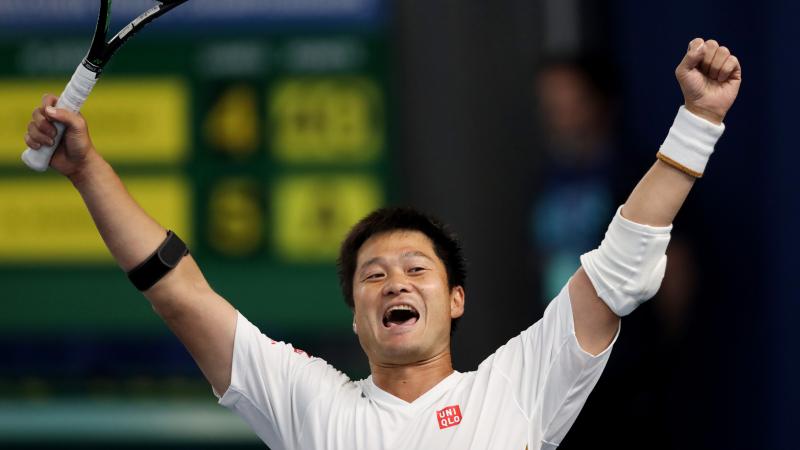 Japanese wheelchair tennis player Shingo Kunieda lifts his arms after winning the final