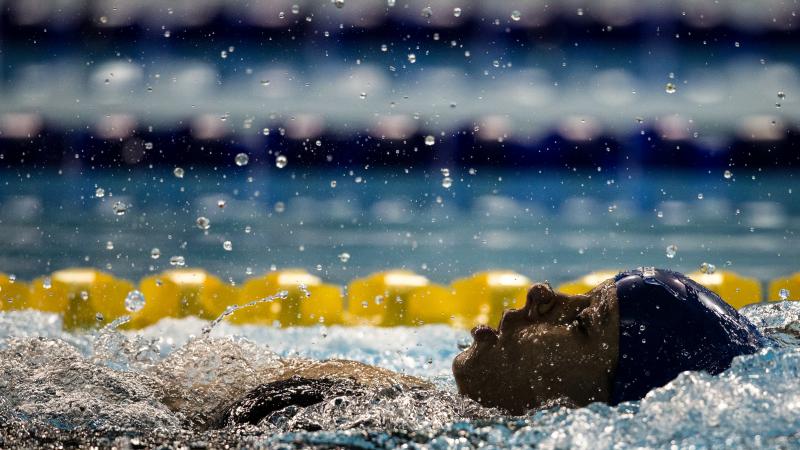 A woman swimming backstroke