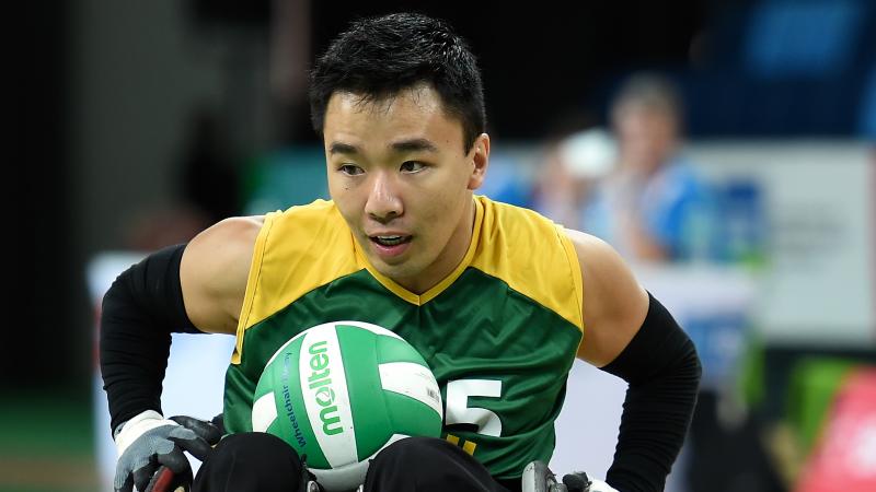 Brazilian man in wheelchair rugby has ball on lap