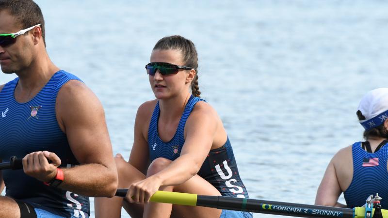 Woman in rowing boat holds an oar