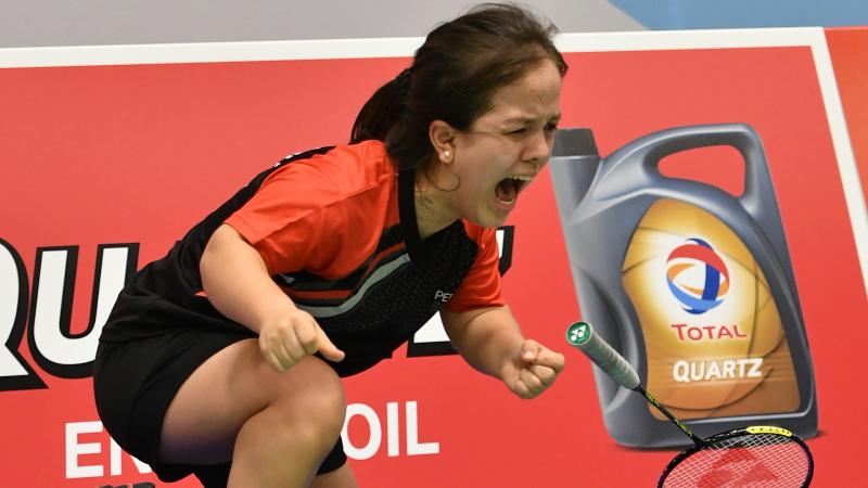 Female short statured woman screams in celebration after winning a World Championship title