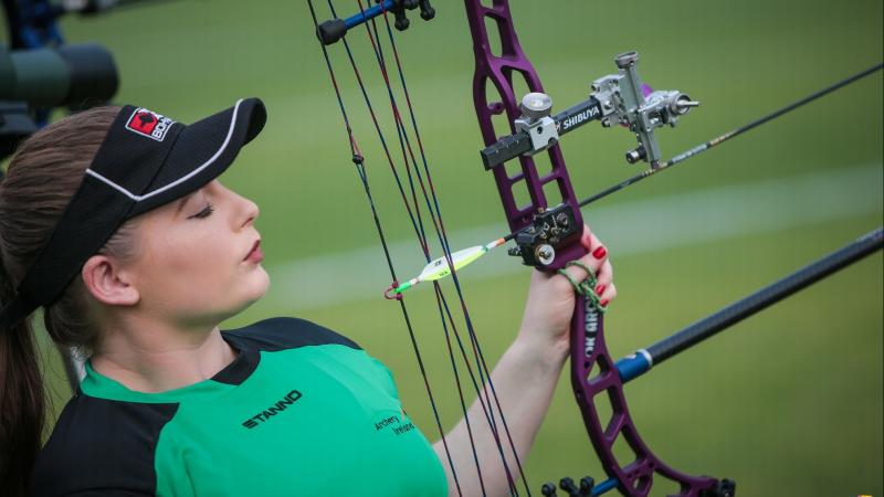 Female Irish archery looks her her bow and arrow