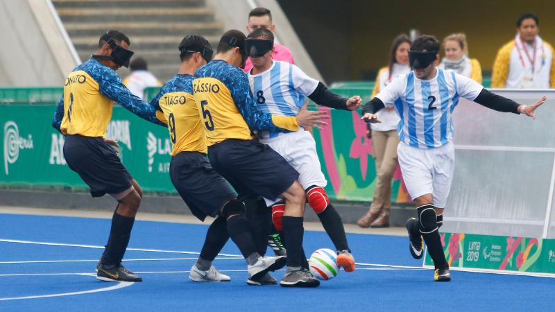 male blind footballers tackling for the ball