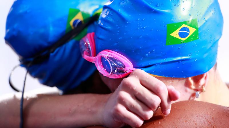 two female Para swimmers hugging