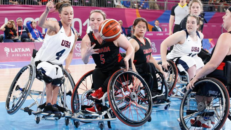 female wheelchair basketball players fight for the ball