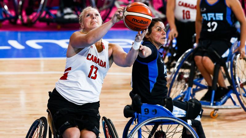 female wheelchair basketball players fight for the ball