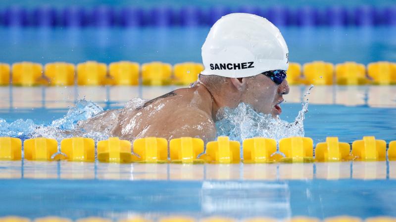 a male Para swimmer doing a breaststroke in the pool