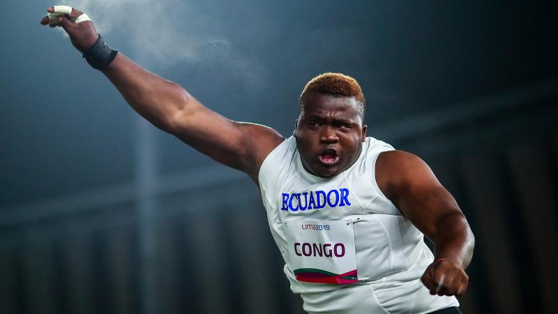 a male Para athlete throws a shot put