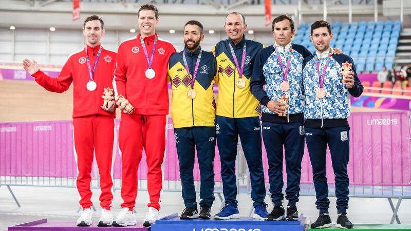 six cyclists on a podium with medals around their necks