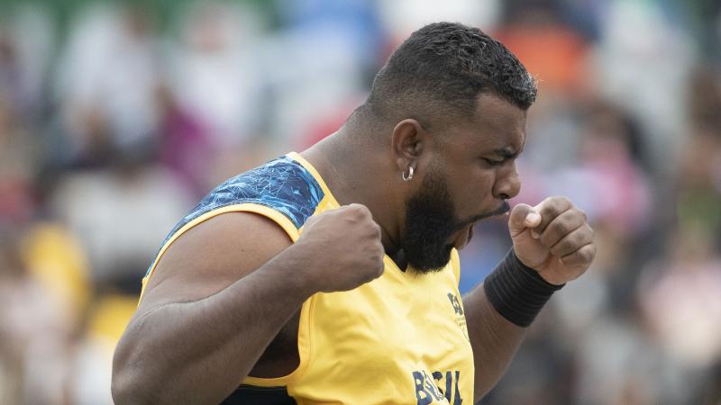 a male Para athlete screams in celebration with his fists clenched