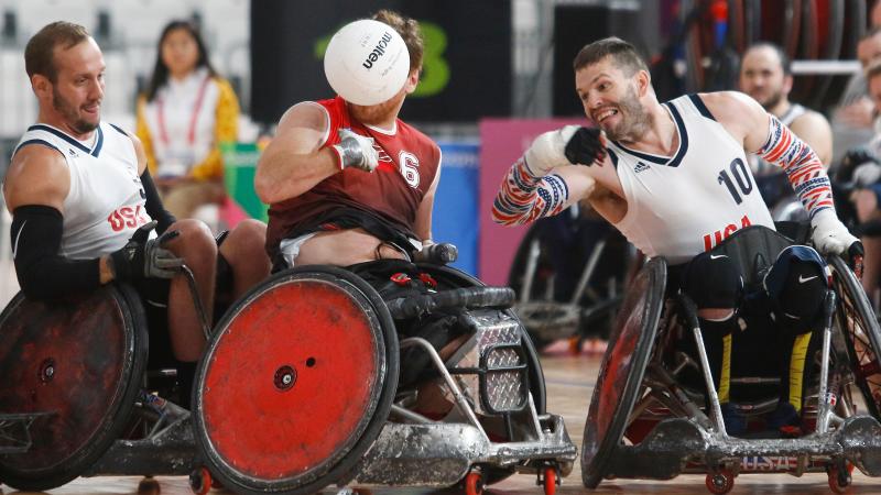 male wheelchair rugby players fight for the ball