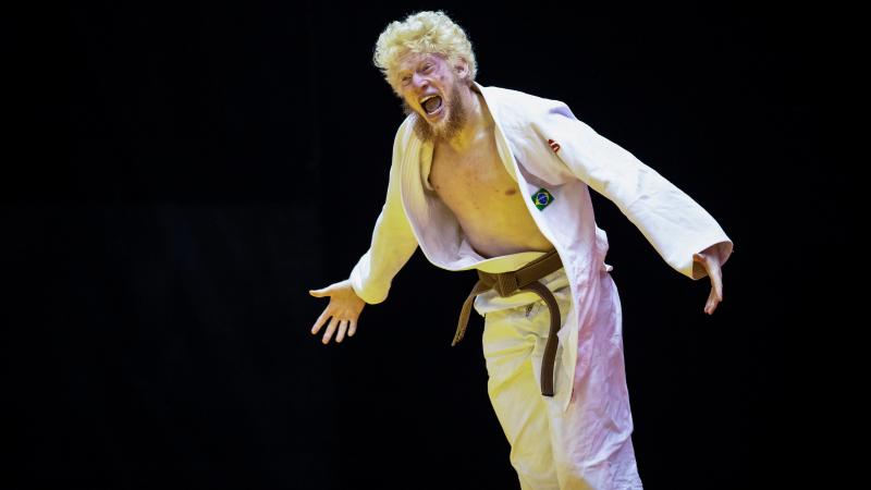 a male Para judoka celebrates