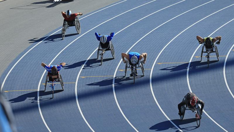 male wheelchair athletes going round the bend of the track