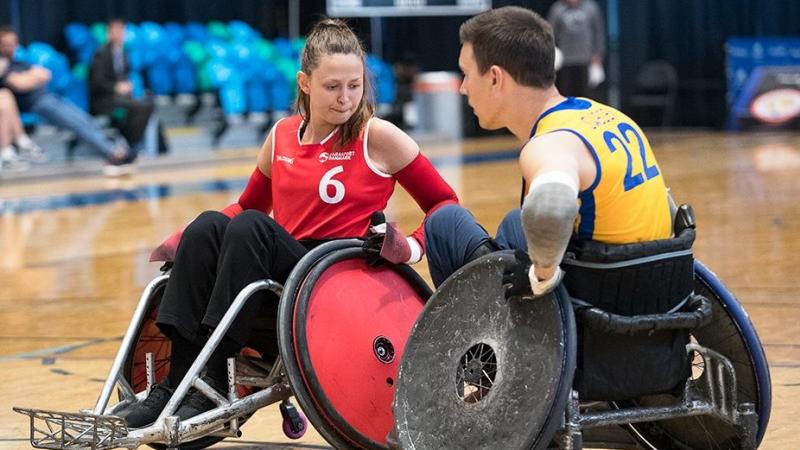 Female Danish wheelchair rugby player stops a Swedish male player with her chair