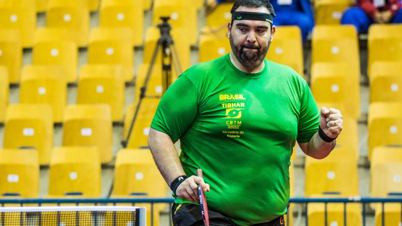 Brazilian male table tennis player clutches fit to celebrate a point