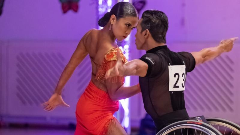 Female standing dancer dancers with male wheelchair dancer