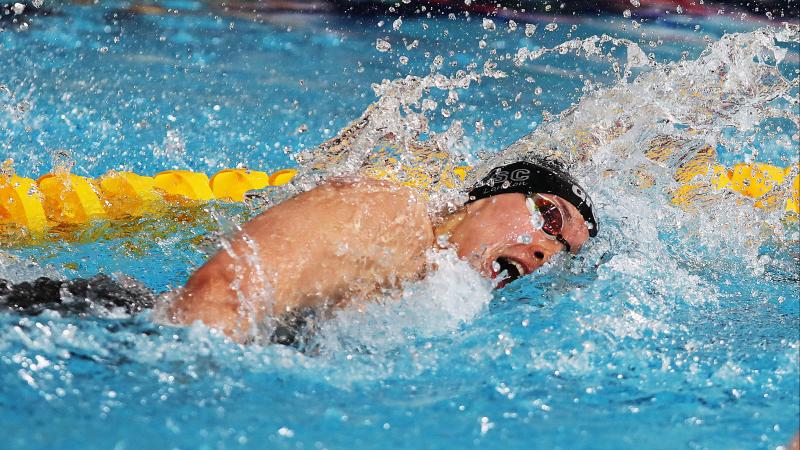 a female Para swimmer swimming freestyle