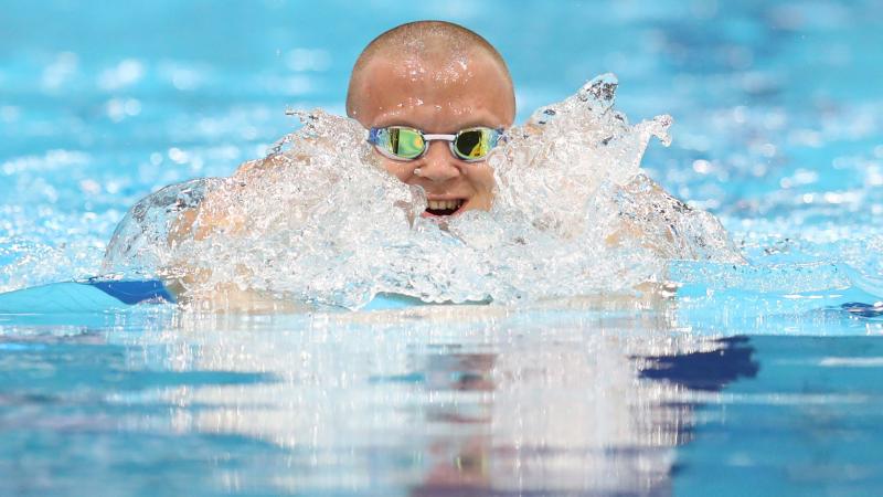 a male Para swimmer doing a breaststroke in the pool